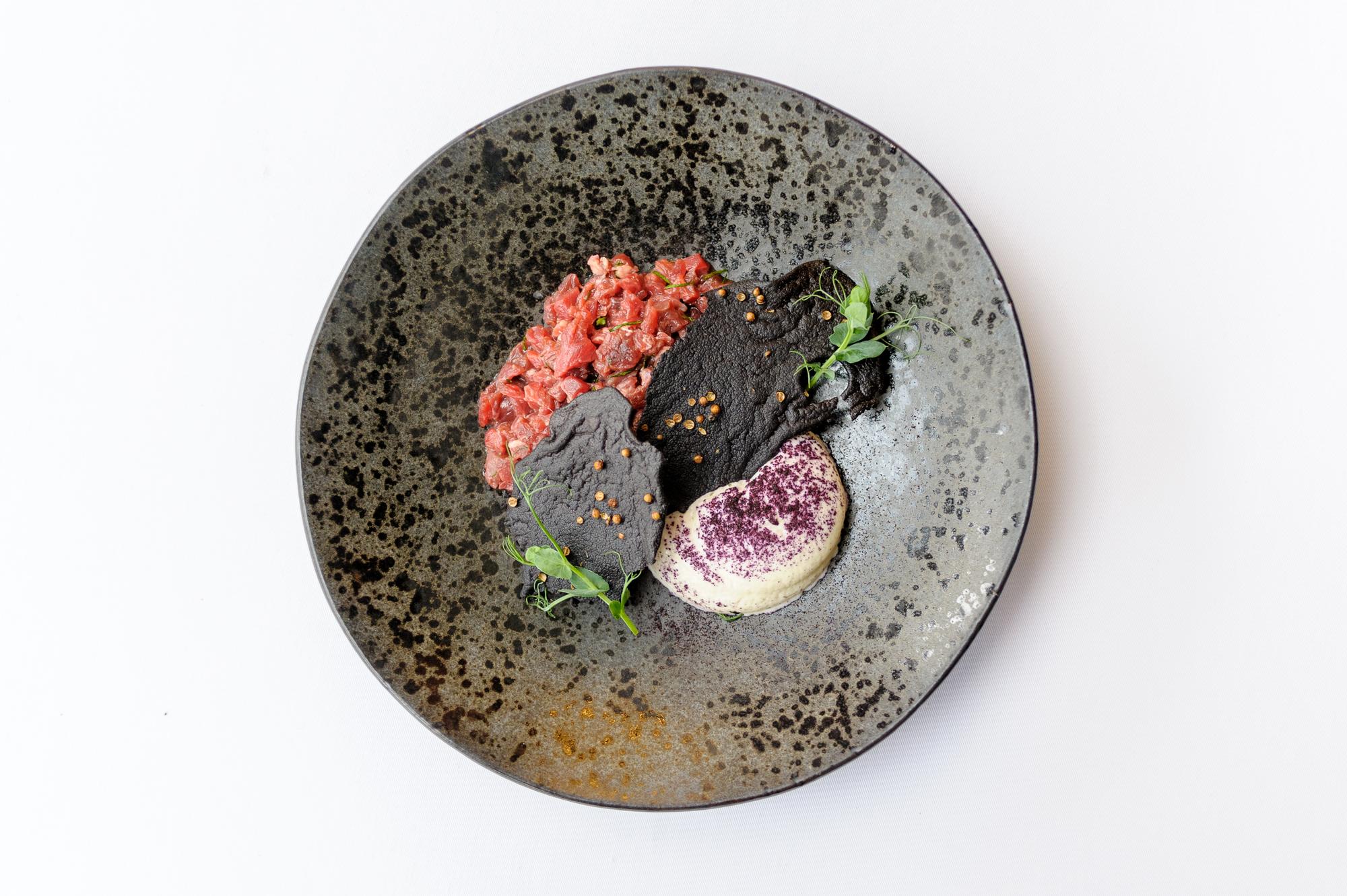 Large editorial image of a plated tasting menu with overlapping secondary photos